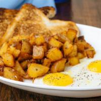 American Breakfast · Three eggs any style, confit potatoes, choice of toast with homemade berry marmalade.
