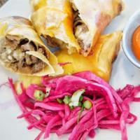 Cheesesteak Spring Rolls  · Ribeye, provolone, caramelized onions, mildly spicy tomato sauce for dipping.