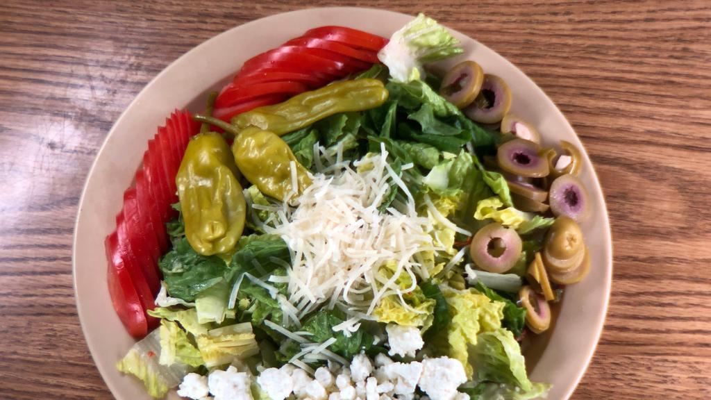 Greek Salad · Lettuce, tomatoes, green olives, and pepperoncinis. Topped with feta and Parmesan cheeses.