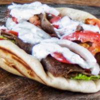 Gyro · Pita bread, sliced lamb meat, lettuce, tomatoes, red onions, and gyro sauce.