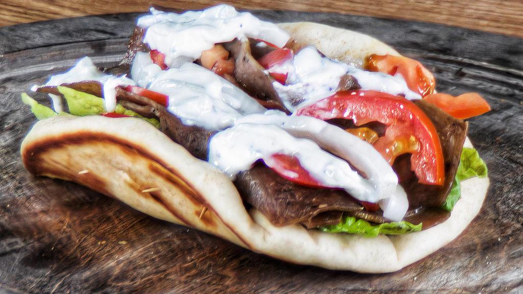 Gyro · Pita bread, sliced lamb meat, lettuce, tomatoes, red onions, and gyro sauce.