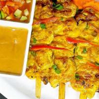 Chicken Satay · Grilled seasoned chicken with satay sauce and yellow curry powder, served with peanut sauce ...