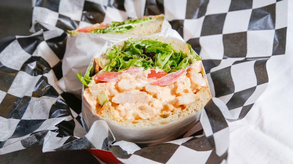 Shrimp Salad Sandwich · Served with mixed greens, red onion, tomato, and house aioli.