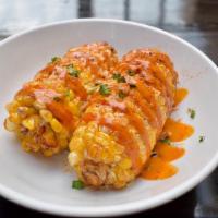 Street Corn · Corn on the cob covered in chipotle ranch, spices, and cheese.