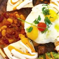 Brisket Huevos Rancheros · Flour tortillas stuffed with pulled beef brisket and cheddar cheese; beans in a chunky tomat...