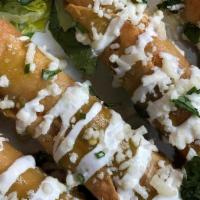 Chicken Taquitos* · Chicken Taquitos (4) fried and served with queso fresco, lettuce, pico de gallo, and a drizz...