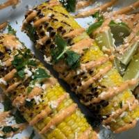 Grilled Elote (Gf)* · one grilled corn topped with chipotle mayo, cotija cheese, cilantro, lime