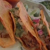 Birria Taco · slow cooked beef and cheese served on an enchilada tortilla, topped with cilantro, onions an...
