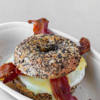 The Cure Breakfast Sandwich · Bacon, two eggs, cheddar cheese on a toasted everything bagel.