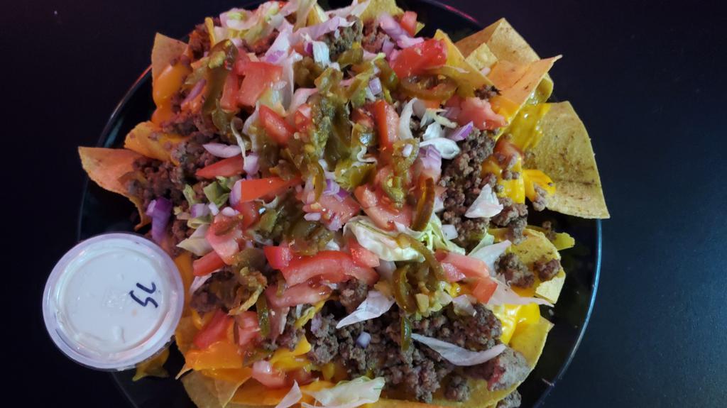Nachos Grande · Nachos, taco beef, cheese whiz, lettuce, tomato, onion and jalapeños served with sour cream and salsa upon request.
