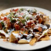 Nachos · Include beans, cheese, sour cream, guacamole, pico de gallo.