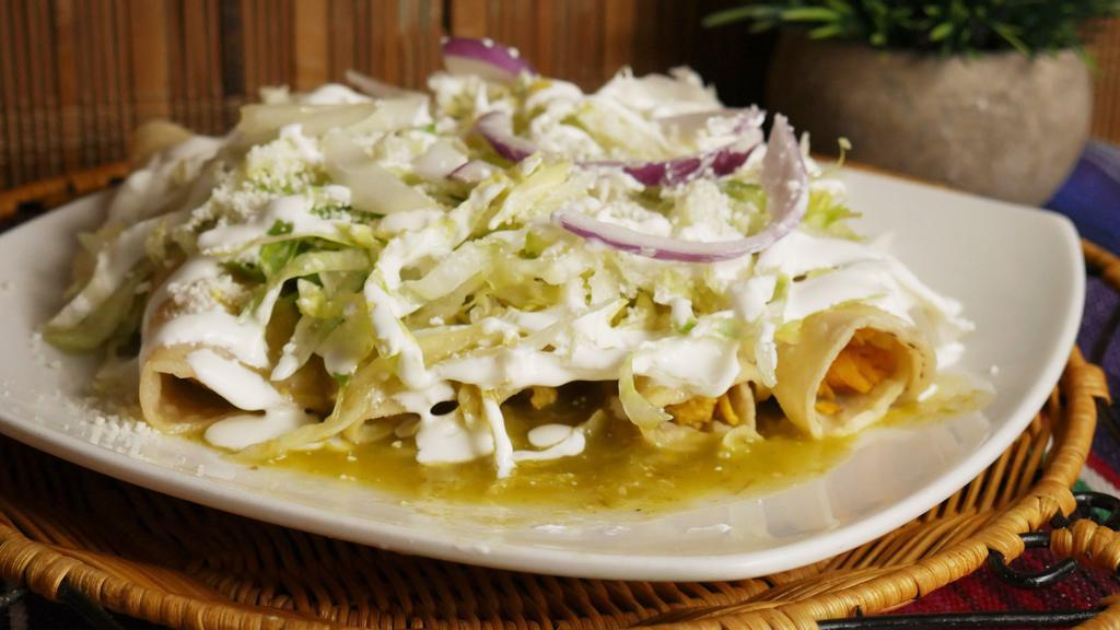 Enchiladas · 5 rolled tortillas stuffed with chicken in green sauce. Topped with lettuce, Mexican cheese, and sour cream. Onions optional.