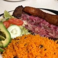 Steak And Onions (Bistec Encebollado) · Steak, Onions, Rice, Beans, Sweet Plantains and Green Salad.