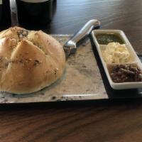 Bread Service · shareable rustic roll served with pesto,
herbed garlic butter, & olive tapenade