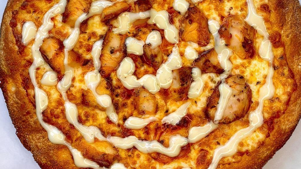 The Buffalo Pizza · Blue cheese spread, cheese blend, grilled chicken, and drizzled with our hot or mild buffalo sauce.