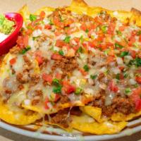 Nachos Fiesta · Choice of shredded chicken, ground beef, or pork, topped with melted Cheddar cheese, refried...