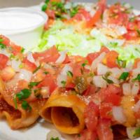 Taquitos · Shredded chicken rolled in corn tortillas, fried until crispy. Topped with salsa roja, pico ...