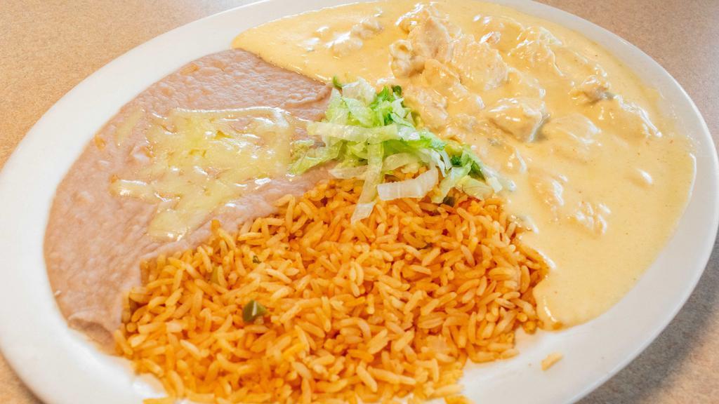 Pollo Con Crema · Tender chicken strips cooked with sour cream, Parmesan cheese and fiesta sauce, served with tortillas, Mexican rice and refried beans on the side.