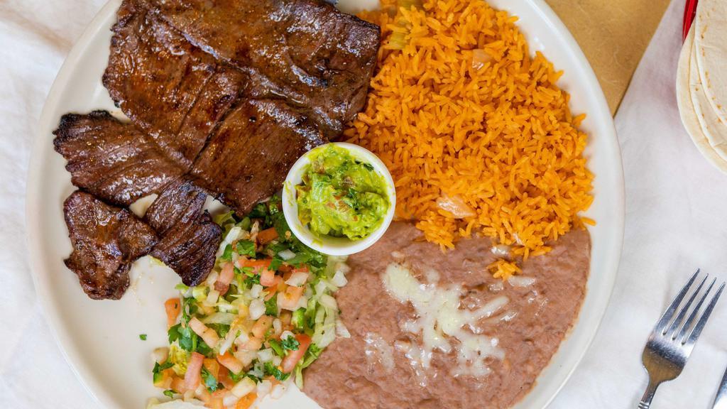 Carne Asada · A delicious half pound skirt steak perfectly seasoned, sliced thin, and served with Mexican rice, refried beans, pico de gallo, and guacamole.