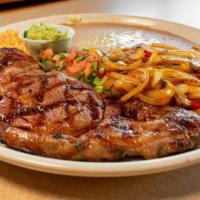 Ribeye Steak · A 10 oz ribeye steak topped with sautéed onions, bell peppers, and mushrooms. Served with Me...