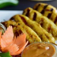 Satay Chicken · Charcoal-grilled chicken on bamboo skewers. Served with peanut sauce and cucumber sauce.