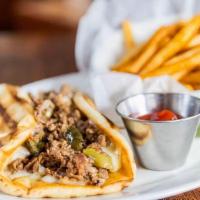 Angus Ribeye Cheesesteak Pita · Shaved rib eye, caramelized onions, roasted peppers, . Muenster, provolone, grilled panini f...