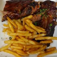Baby Back Ribs · Slow roasted full rack of baby back ribs, hickory smoked BBQ sauce, served with beer battere...
