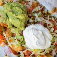 Nacho Fries · tomatoes, jalapenos, chopped onion, guacamole, lettuce, cheddar jack cheese, sour cream