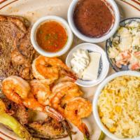 Carne Asada Con Camarones · Grilled meat with shrimp served with rice, Russian salad, fried beans, avocado, chirmal, sca...