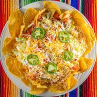 Super Nachos · Chips covered with nacho cheese, beans, lettuce, pico de gallo (salsa), sour cream and jalap...
