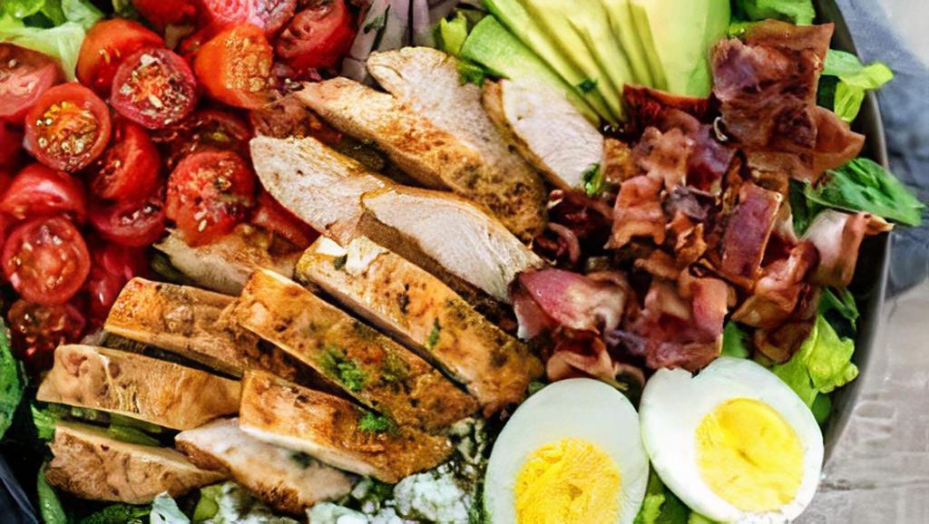 Cobb Salad · Grilled chicken breast, bacon, Blue cheese, tomato, cucumber, Bermuda onion, hard boiled egg, mixed greens.
