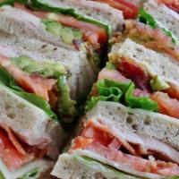 The Club · White Turkey topped with Bacon, Avocado, Swiss, tomato and mayo served on 3 layers of rye br...