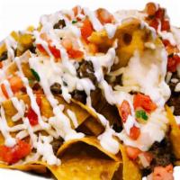 Nachos Grandes · Corn chips topped with Queso, beans, choice of meat, lettuce, pico, guacamole cheese and sou...