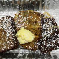 Banana Bread French · 3 slice of home made banana bread french toast topped with butter and sugar