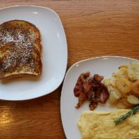 French Toast Deluxe · Two cinnamon French toast, two large farm fresh eggs prepared any style, and breakfast meat ...