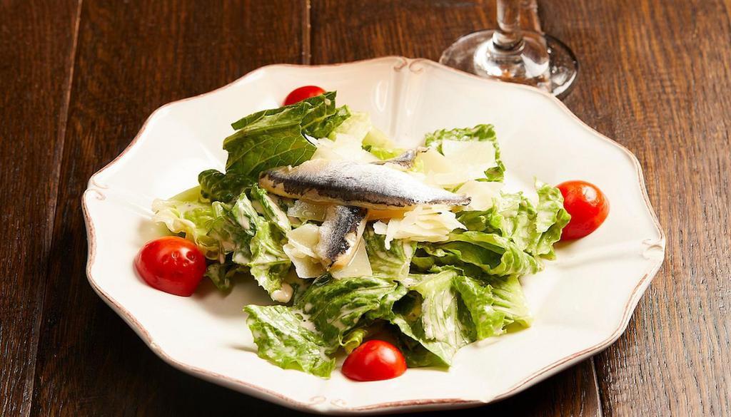 Ensalada De La Casa · Romaine Lettuce tossed in a Garlic Anchovy. Dressing topped with shaved Idiazábal Cheese