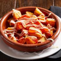 Patatas Bravas · Crispy Potatoes tossed in a Spicy Ali-Oli topped. with garlic Ali-Oli