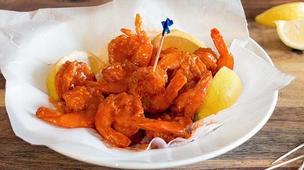 Buffalo Shrimp (5) · Jumbo shrimp coated in seasoned flour, then deep fried to golden brown perfection, tossed in a buffalo sauce.