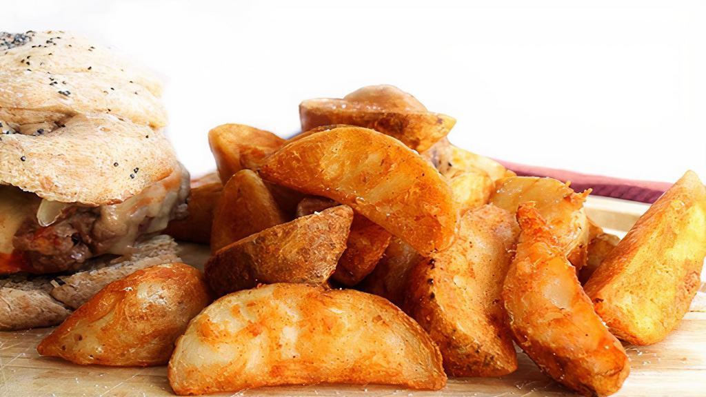 Seasoned Potato Wedges · Crispy thick cut potato wedges that are seasoned and deep fried.