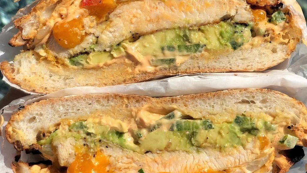 Chipotle Chicken Sandwich · grilled ciabatta, seasoned chicken breast, melted cheddar cheese, sautéed onion & peppers, avocado, cilantro, jalapeños, chipotle cream