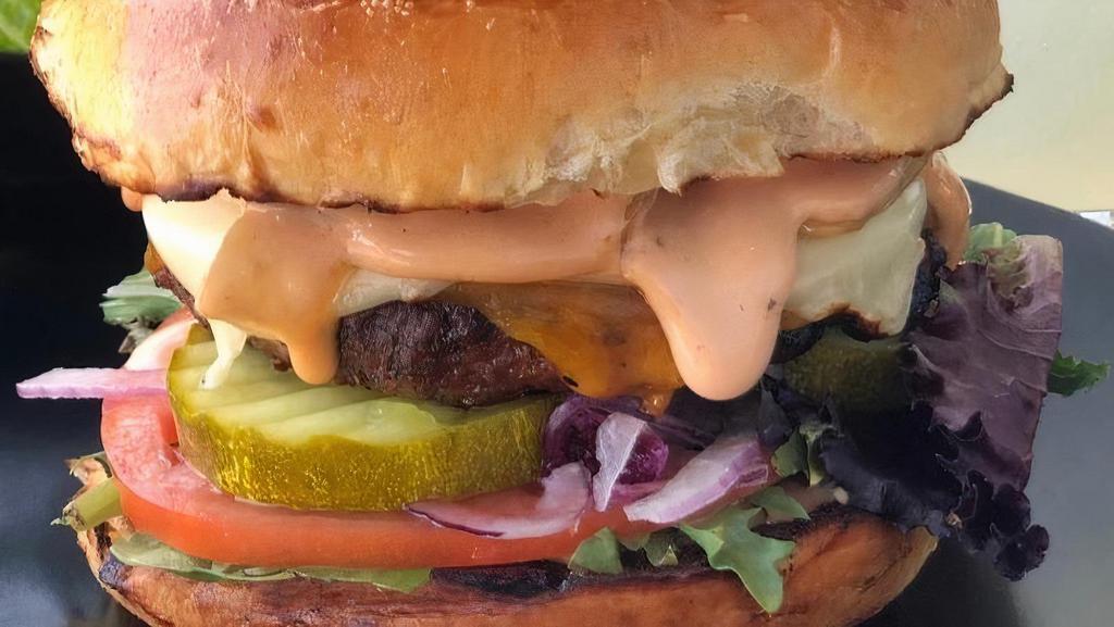Classic Burger · toasted brioche bun, house blend char-grilled beef burger, cheddar & American cheese, caramelized onion, pickle, lettuce, tomato, red onion & house sauce