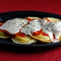 Baked Ravioli · Topped and baked with tomato sauce and mozzarella cheese.