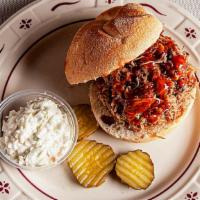 Carolina Pulled Pork Sandwich · Smoked pulled pork served on a kaiser roll with coleslaw and spicy mango BBQ sauce.