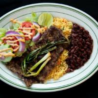 Carne Asada · Grilled steak served with rice, beans, corn tortillas and salad.