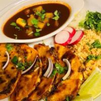 Enchiladas Rojas · Chicken. Enchiladas are served with rice and beans.