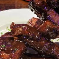 Ribs, Full Rack · Locally sourced Pork Ribs, dry rubbed & slow smoked. Served dry or BBQ glazed.