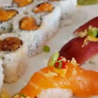 Spicy Madness · Spicy tuna and salmon nigiris and makis, served with spicy cucumber salad, topped with scall...