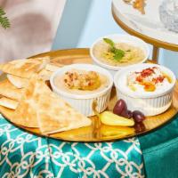 Trio Of Dips · Hummus, baba ganoush, and labneh. Served with warm pita.