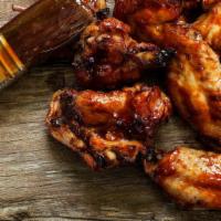Bbq Wings · Fresh baked jumbo chicken wings tossed in a BBQ sauce. Comes with your choice of dipping sau...
