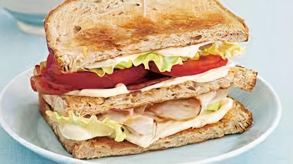 Turkey Club · Fresh sliced Turkey Breast, Bacon, Lettuce and Tomato on toasted White Bread with Mayo. Served with a side of French Fries
